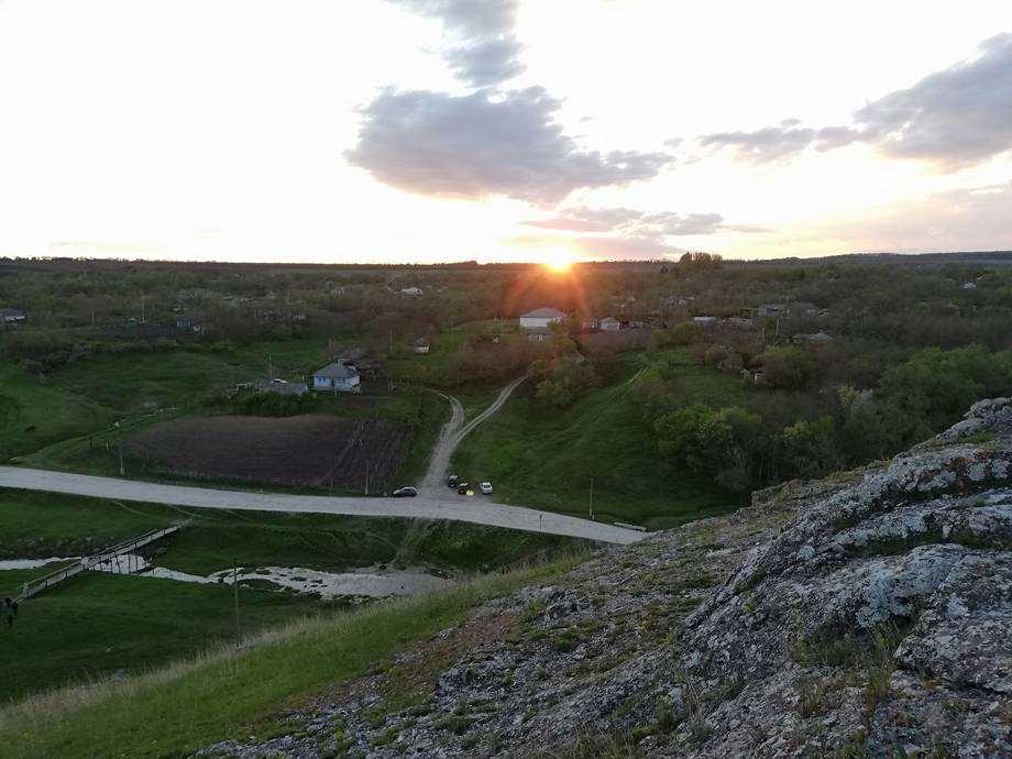Sunset panorama from fortress cliff over river valley and rural landscape