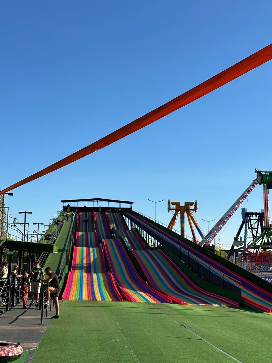Colorful water slides and amusement park rides in daylight