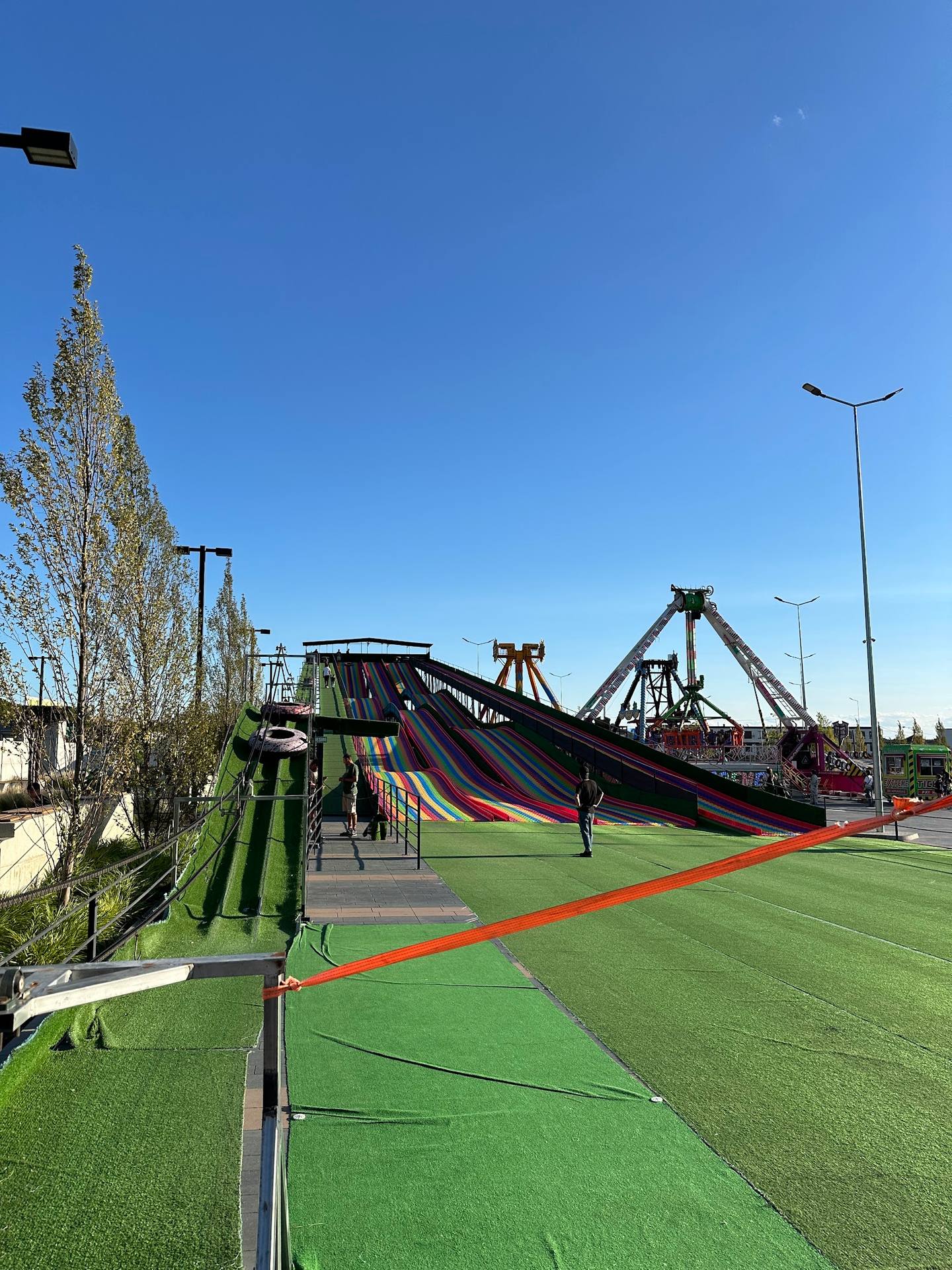 Adventure park with multi-story slide towers and synthetic grass ground