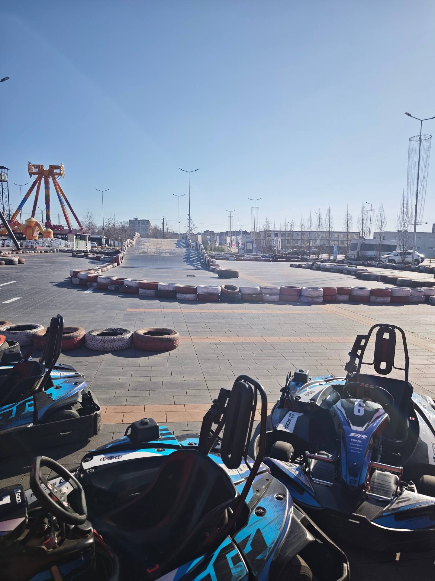 Go-kart racing track with blue and black karts ready for activity