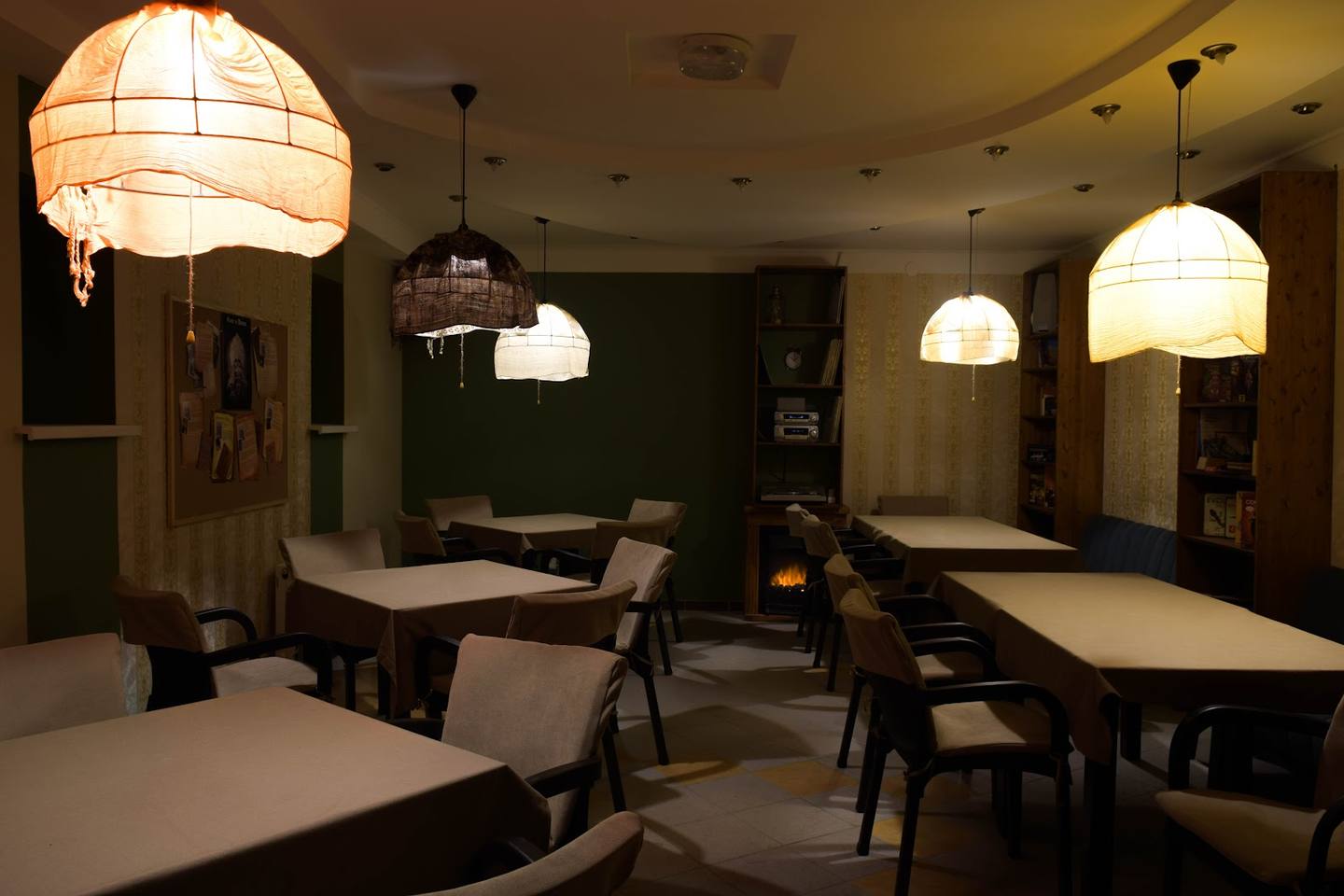 Modern dining space with pendant lighting, clean tables, and contemporary seating