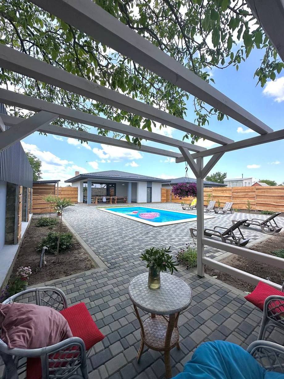 Pergola terrace with pool view and seating area