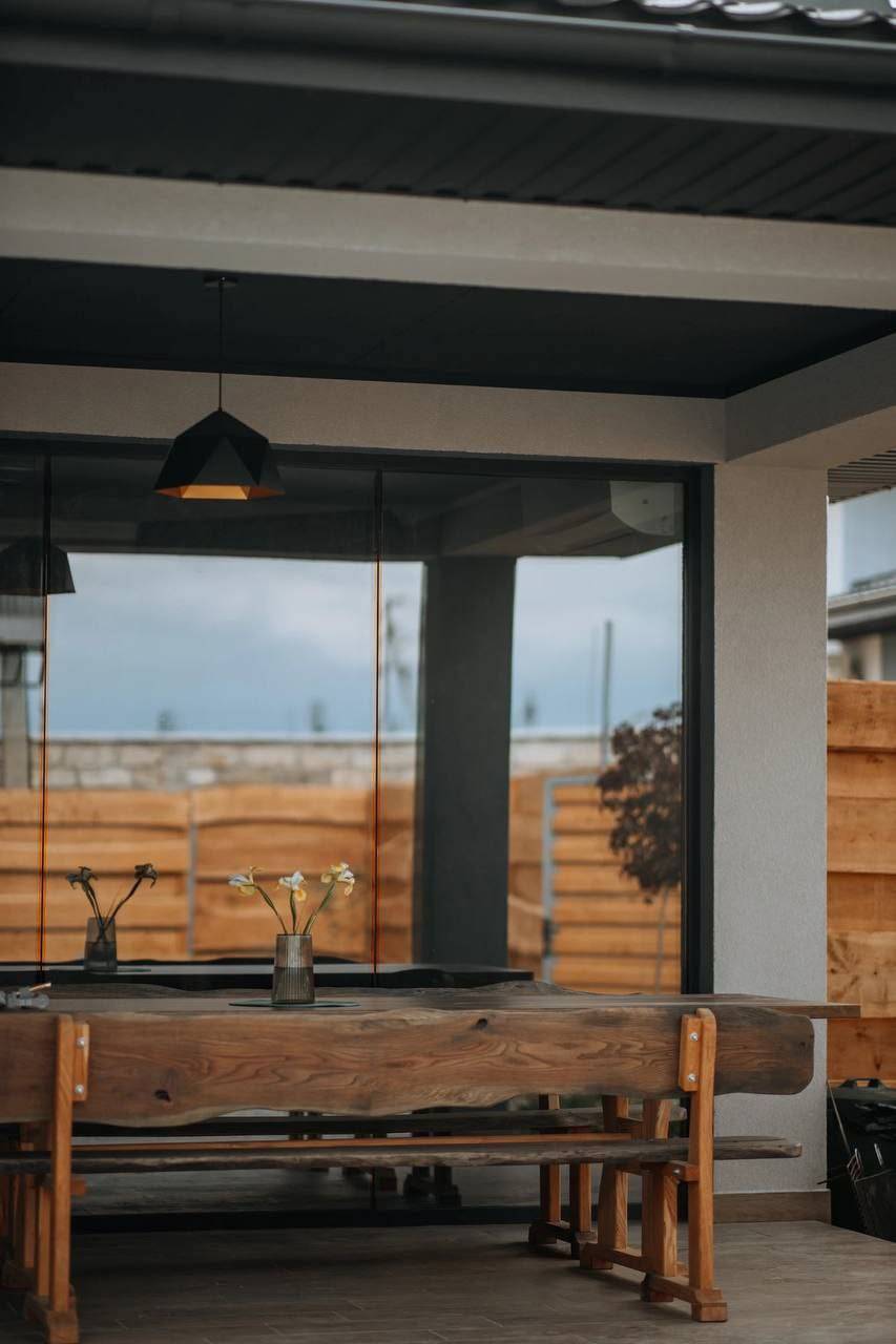 Modern interior with large windows overlooking rolling countryside and fields