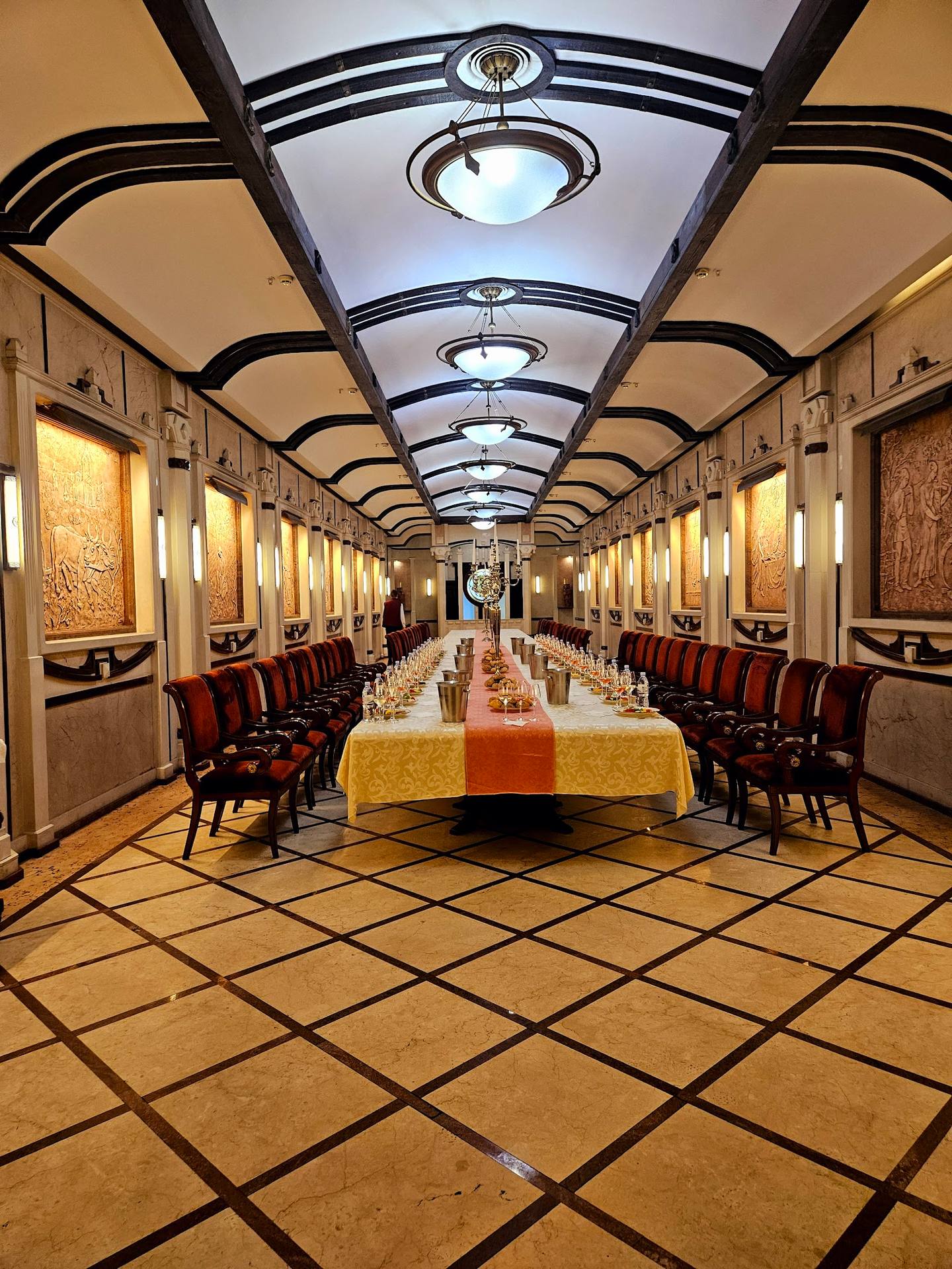 Art deco style private dining room with geometric floor and dramatic ceiling design