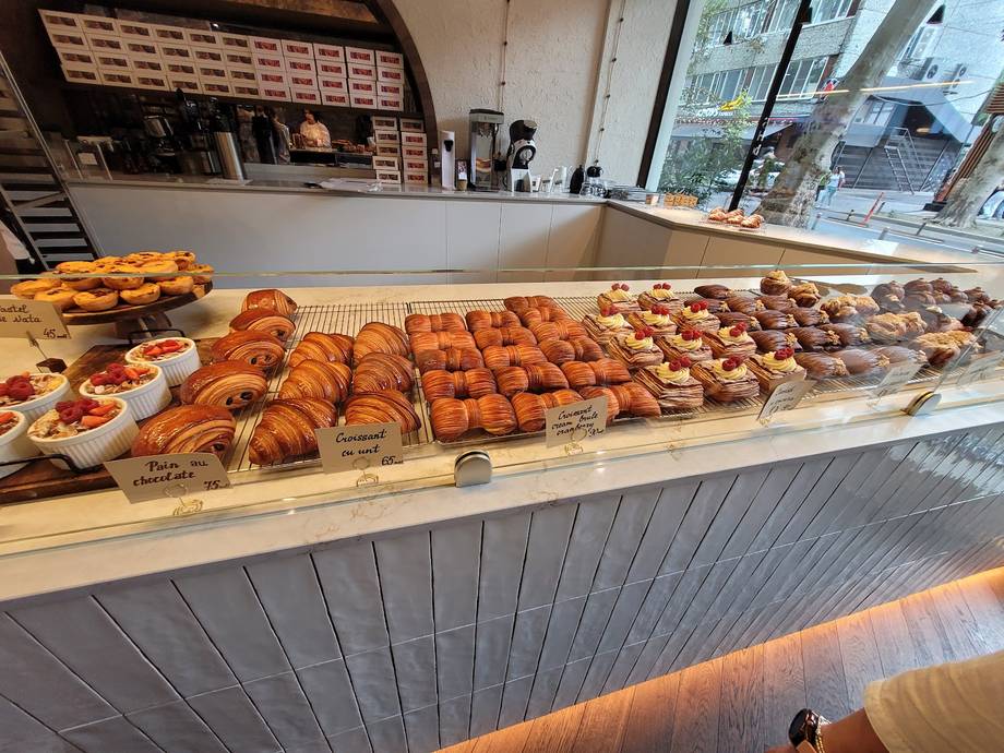 Bakery counter with fresh croissants and pastries on display