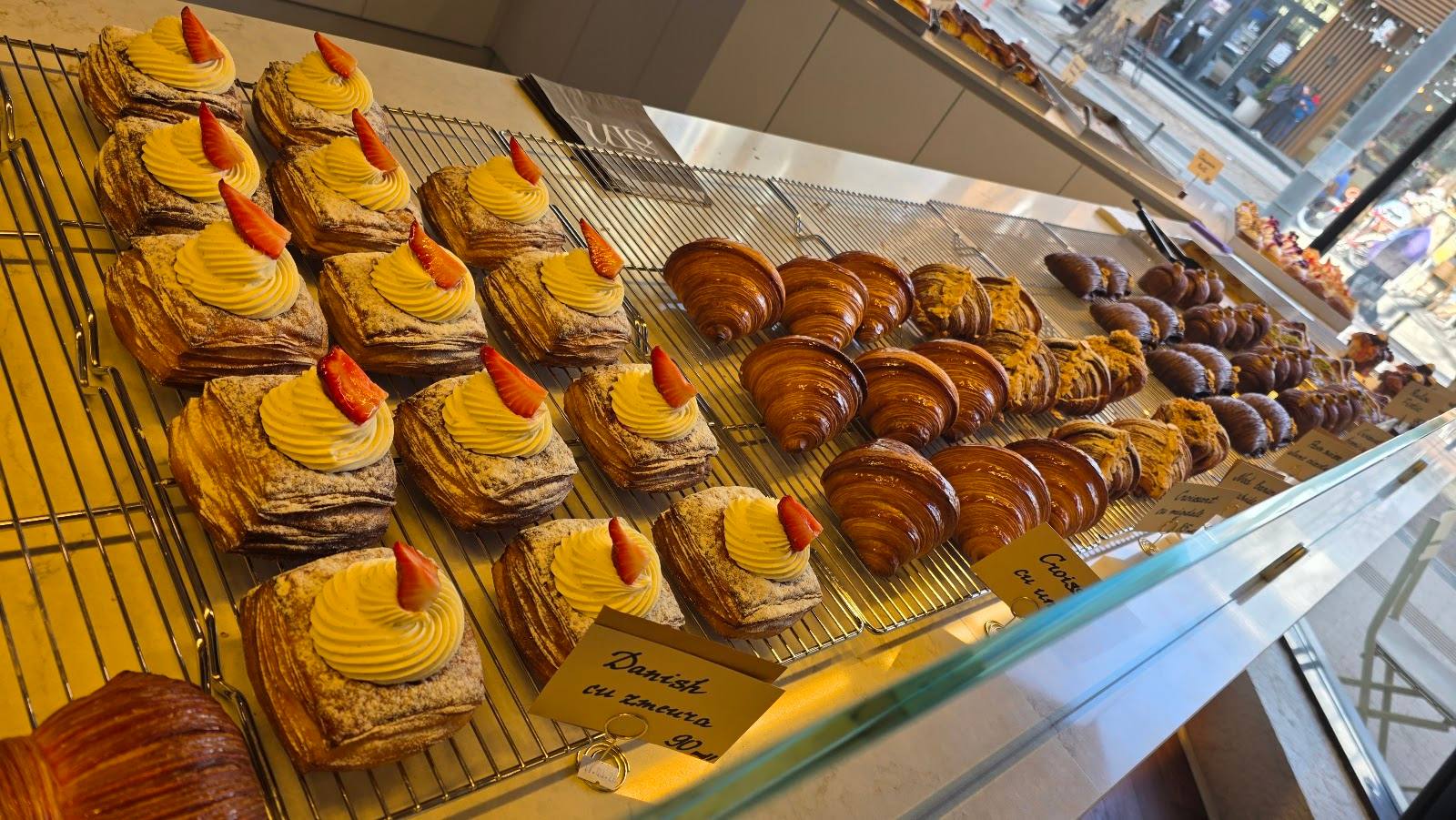 Display of fresh pastries and baked goods in a bakery case