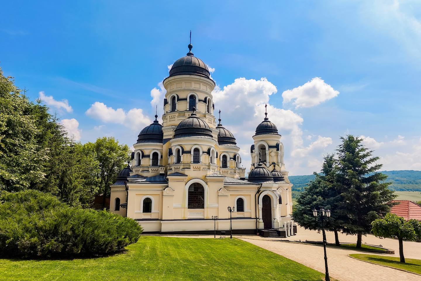 Orthodox monastery with distinctive domed architecture in green landscape setting