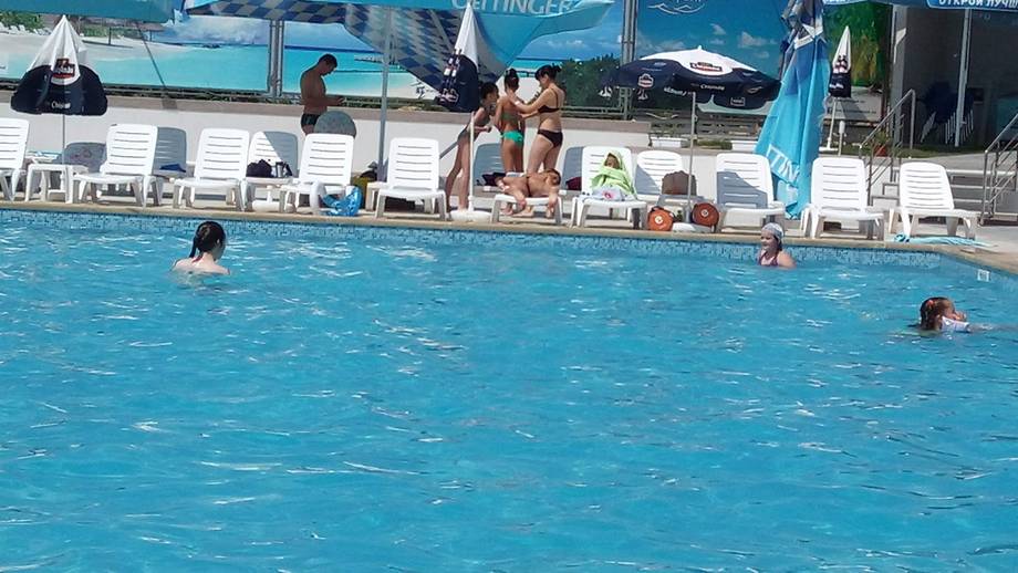 Public swimming pool with activity during daytime operations