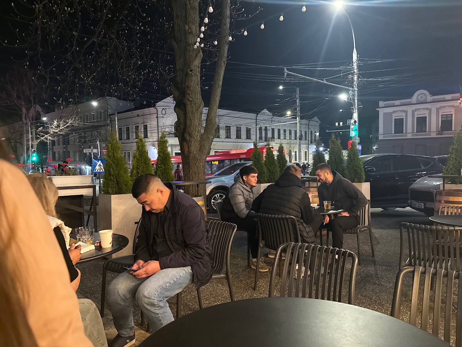 Evening terrace seating with street-level colonial architecture backdrop in Moldova