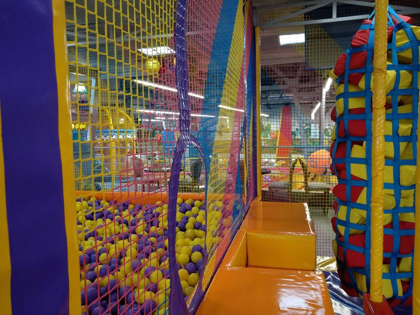 Colorful ball pit and play structures inside an indoor children's activity center