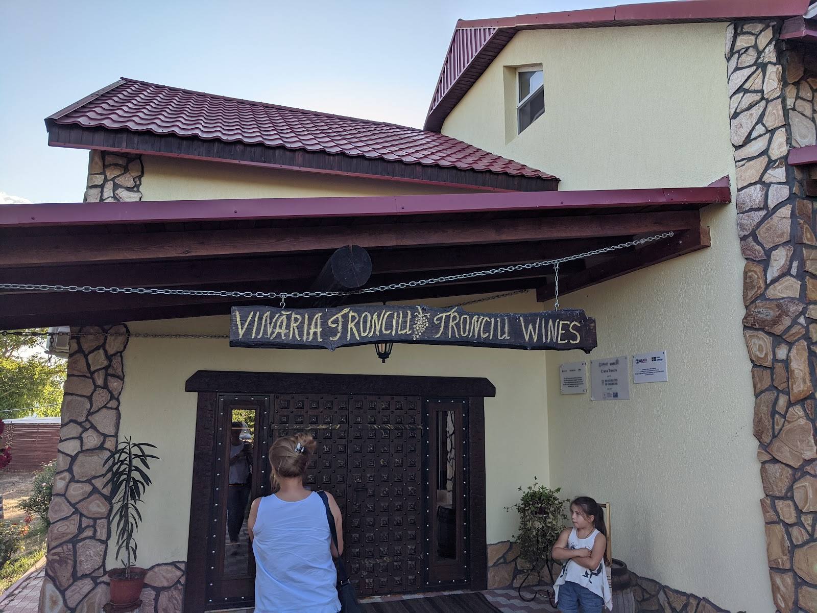 Winery storefront with signage and entrance, showing rustic stone and stucco architecture