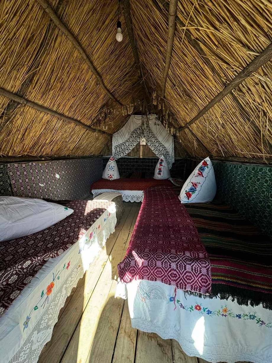 Traditional Moldovan interior of rustic agritourism accommodation with woven reed ceiling and hand-woven textiles