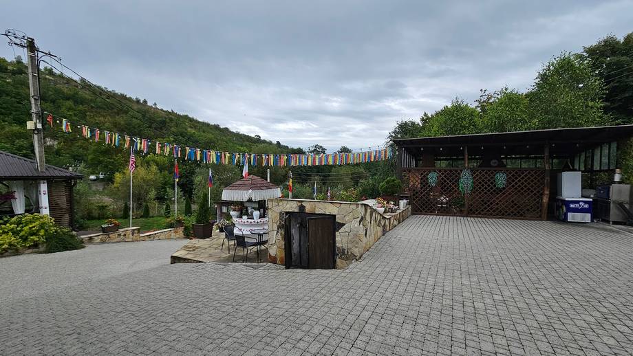Vineyard courtyard with pergola-trained vines and tasting pavilion