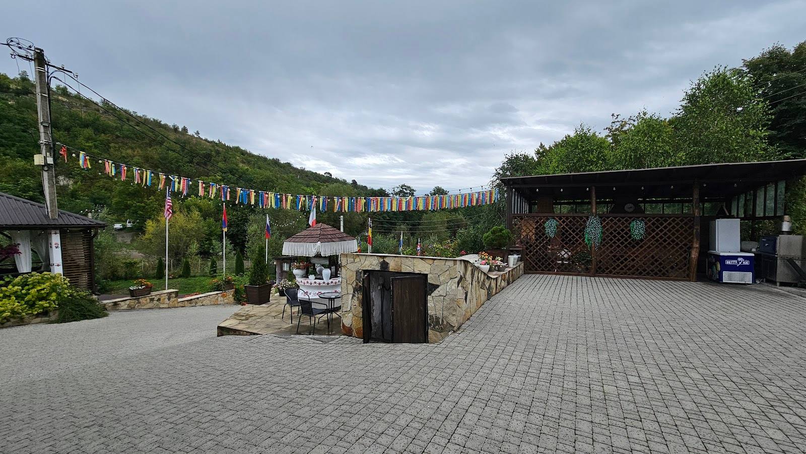 Vineyard courtyard with pergola-trained vines and tasting pavilion