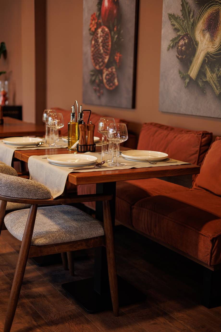 Intimate dining table with warm lighting and mid-century modern seating