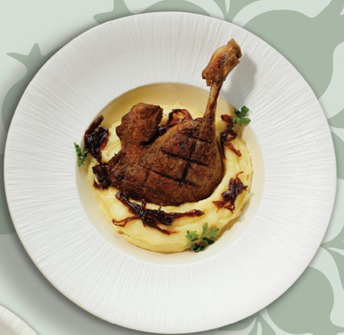 Roasted quail with puree and sauce on white plate