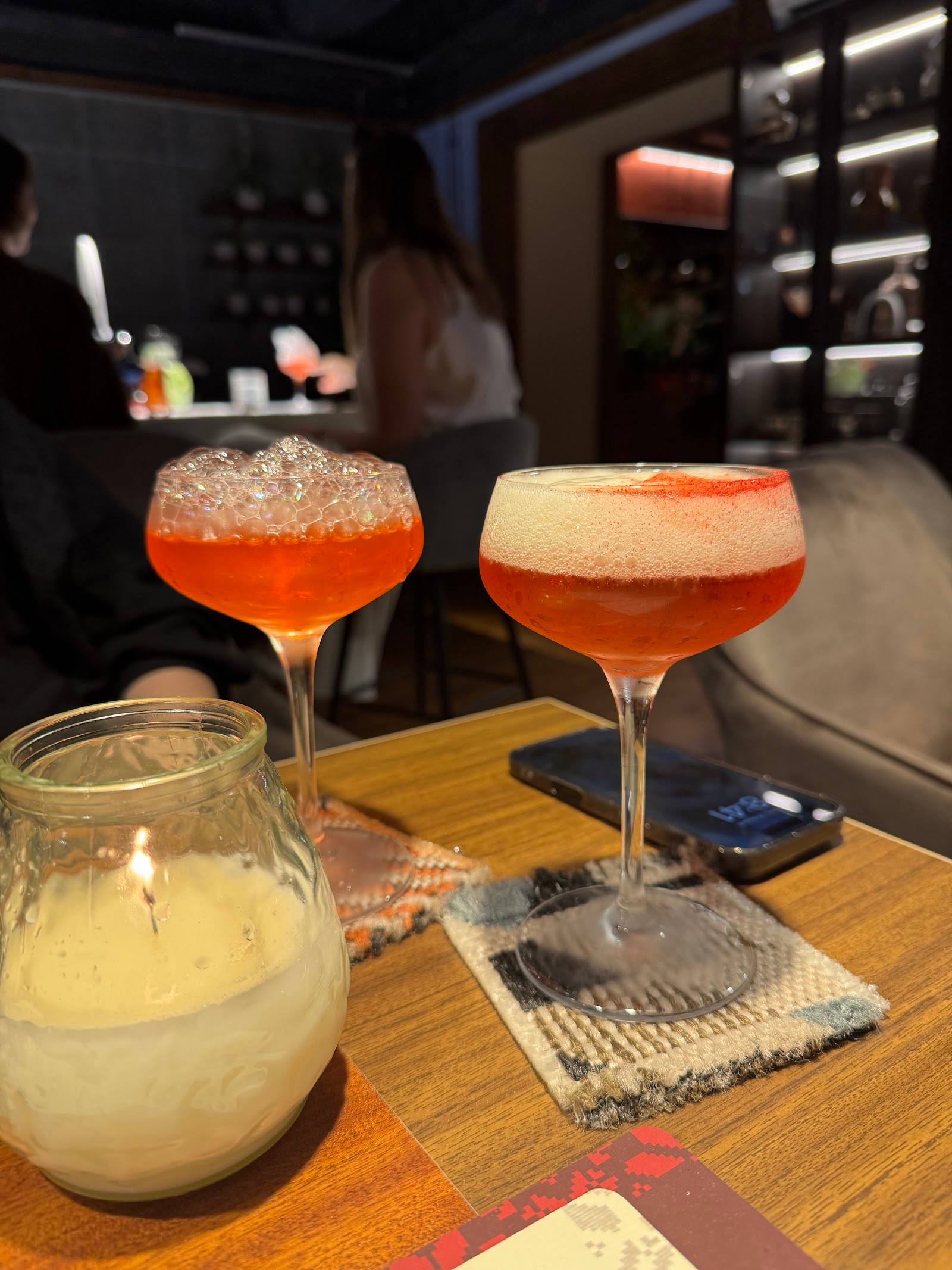 Signature cocktails with detailed garnishes served at the bar counter