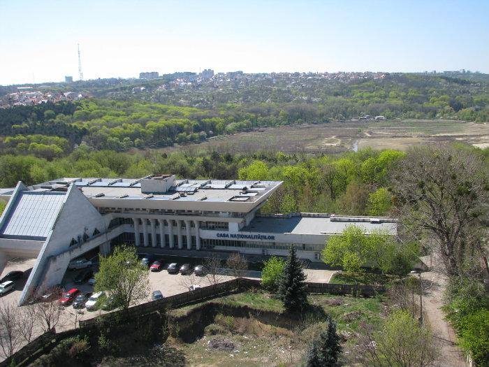 Aerial view of modern venue building nestled in green valley landscape