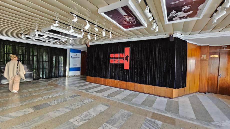 Modern interior space with black architectural features and geometric floor patterns