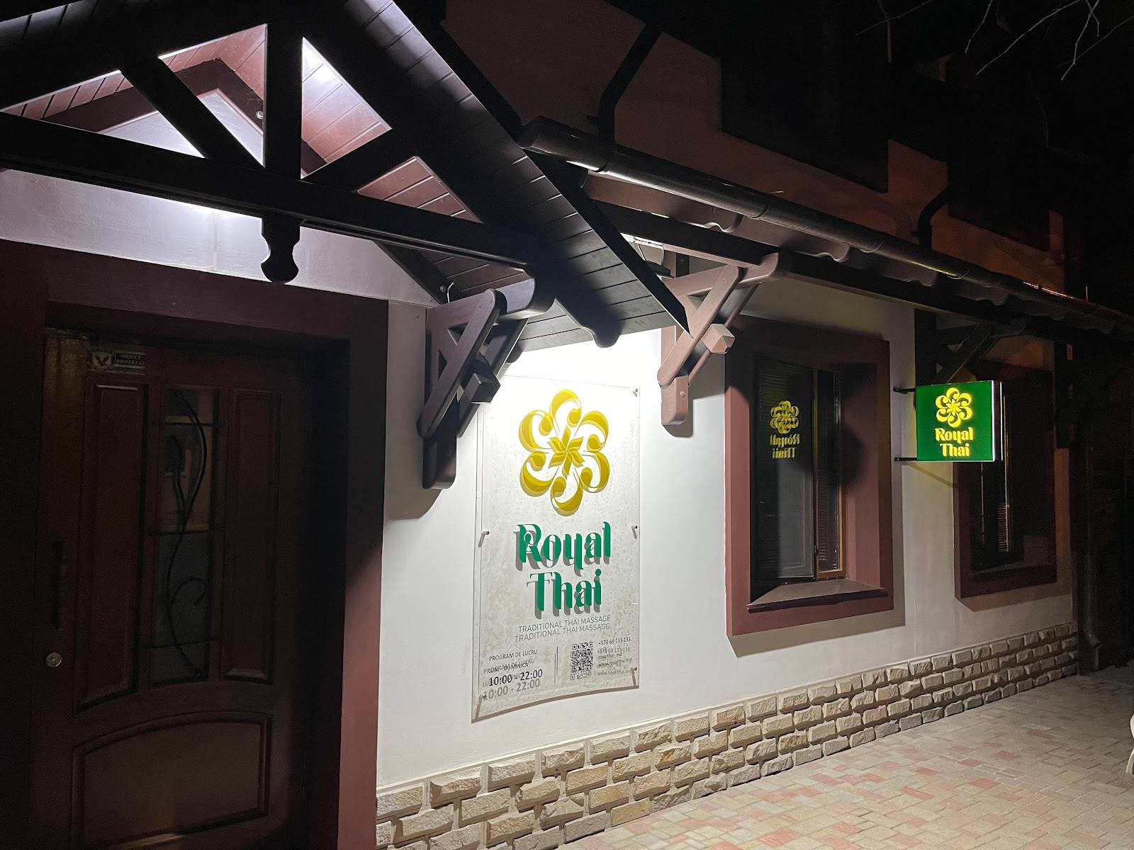 Storefront exterior with illuminated signage and traditional architectural details at night