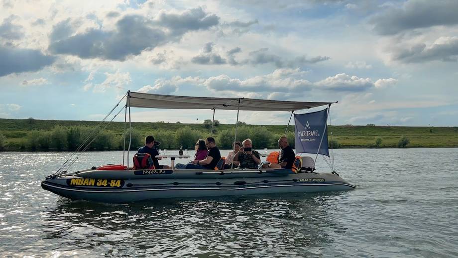 Boat tour on Danube Delta wetlands with visitors under canopy