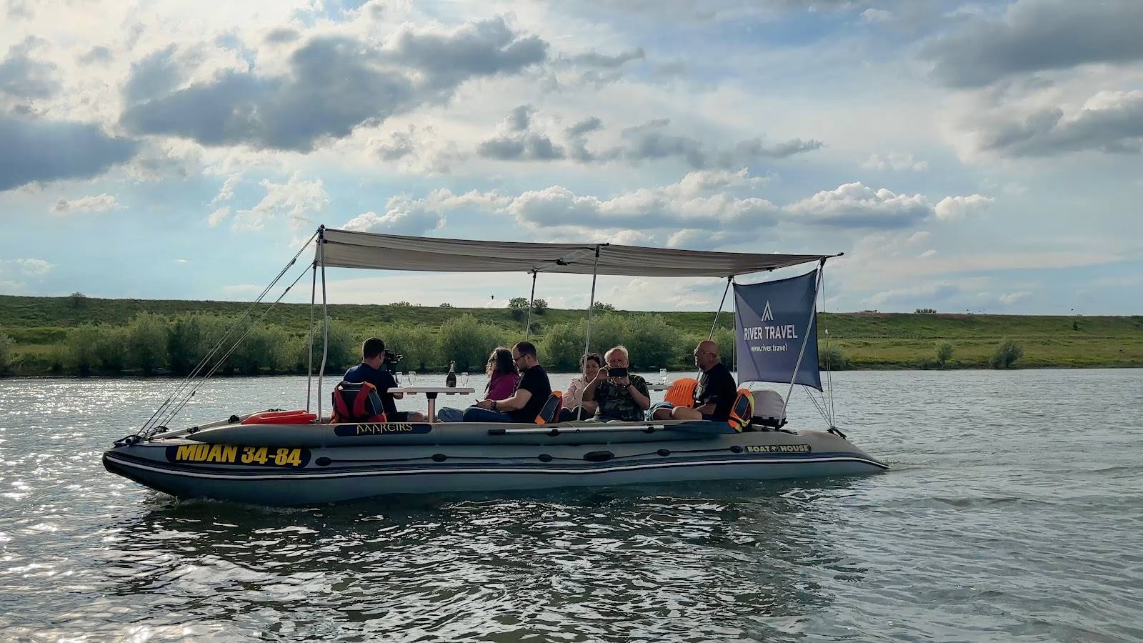 Boat tour on Danube Delta wetlands with visitors under canopy