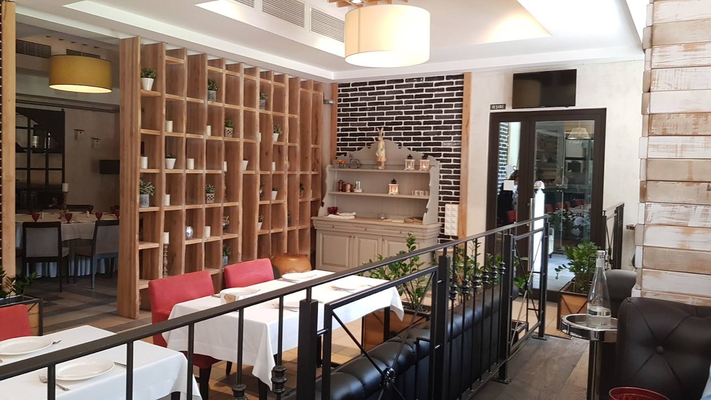 Modern café interior with wooden shelving, dining tables, and natural lighting