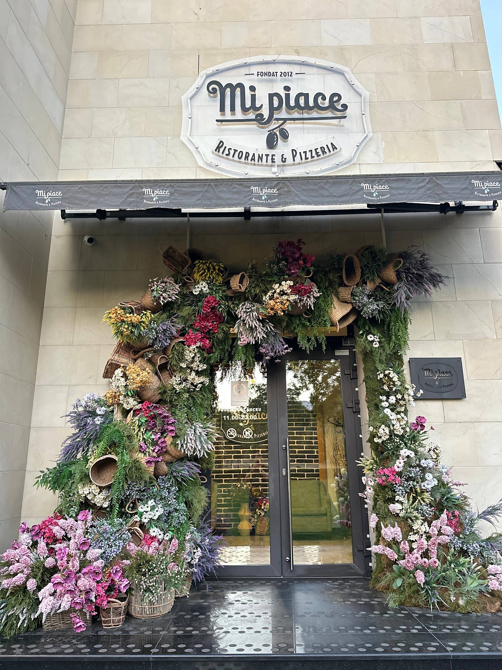 Mt. place restaurant storefront with floral-decorated entrance and signage