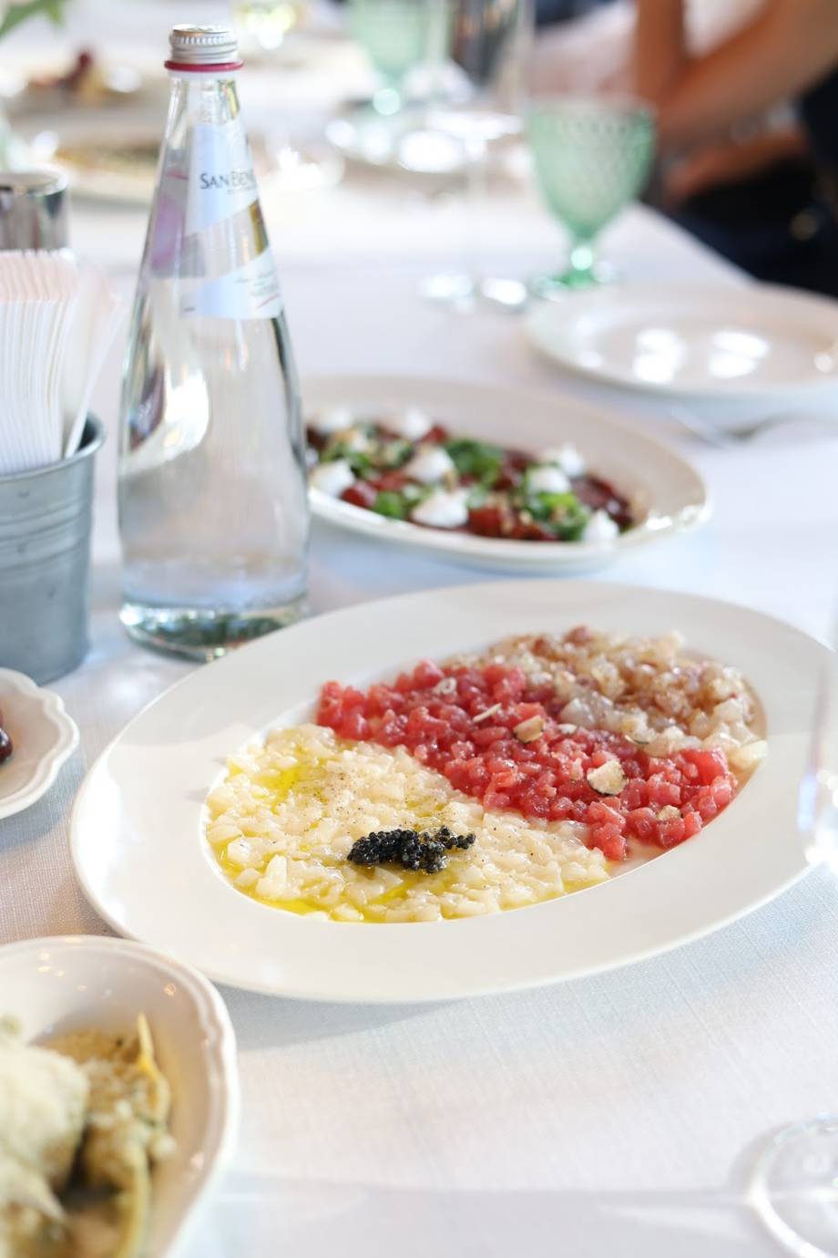 Table setting with gourmet appetizers and sparkling water at fine dining service