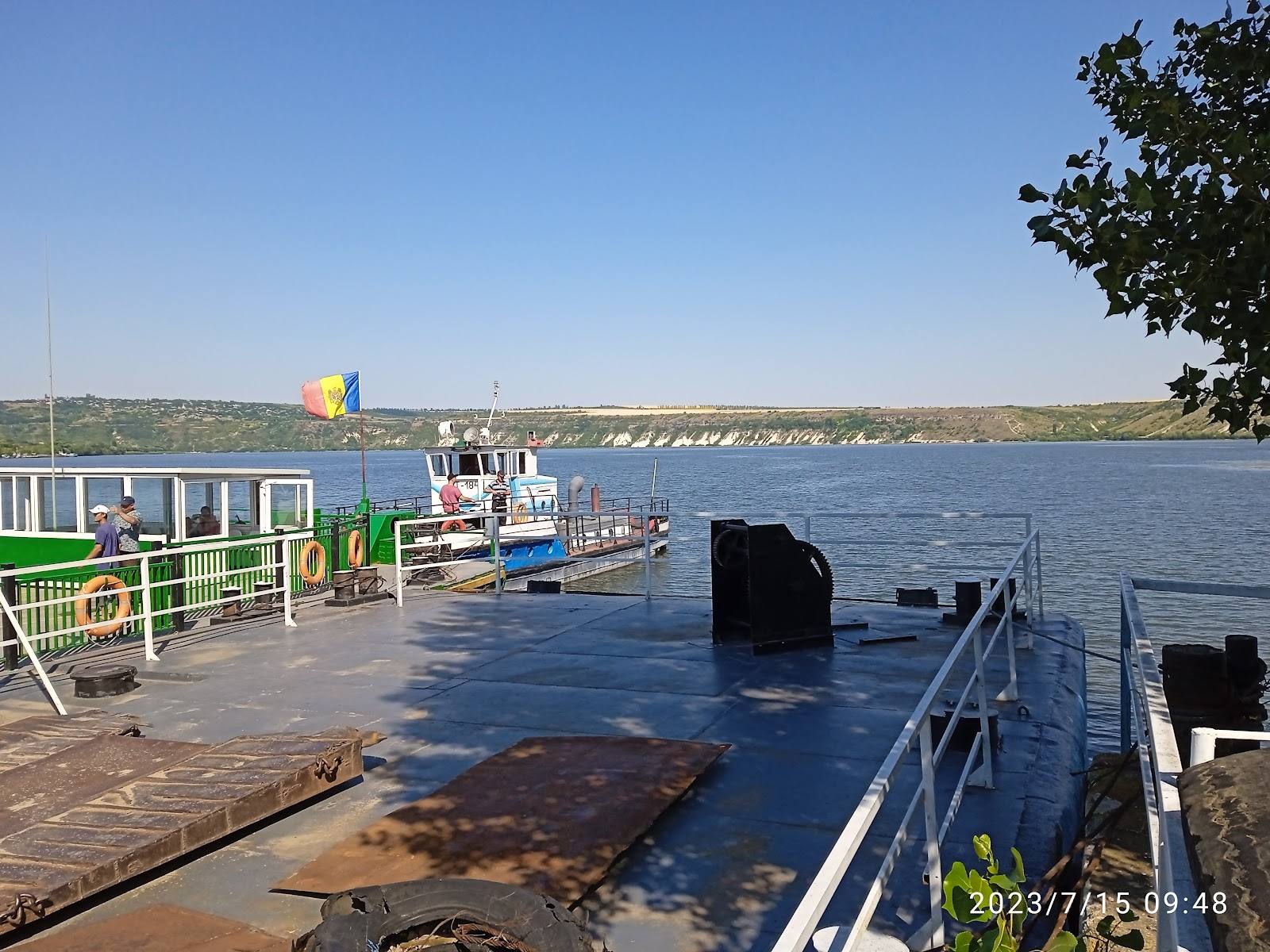 Waterfront terrace with river view and moored boats, ideal for outdoor dining