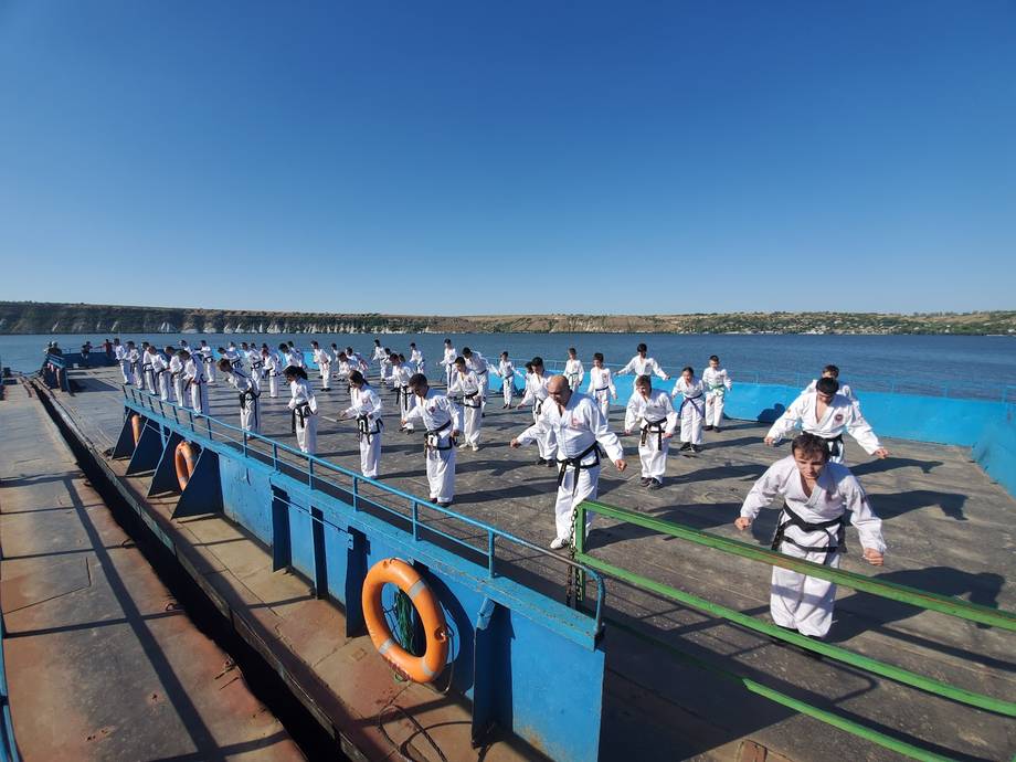 Group event on a boat dock with turquoise water and coastal views
