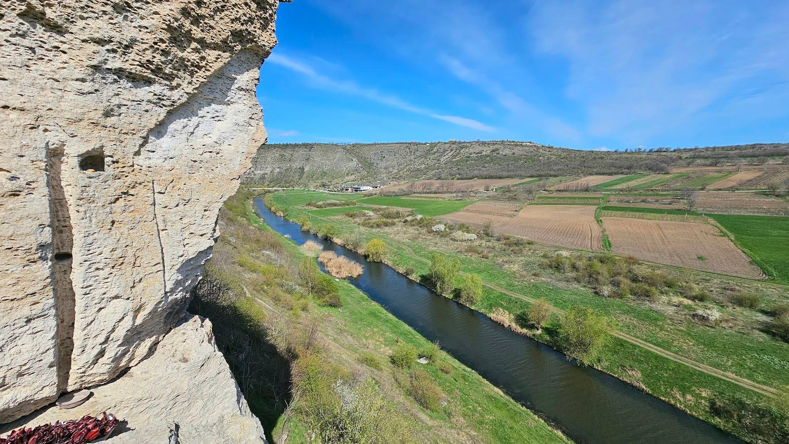 Fortress cliff overlook with river valley panorama and green landscape below