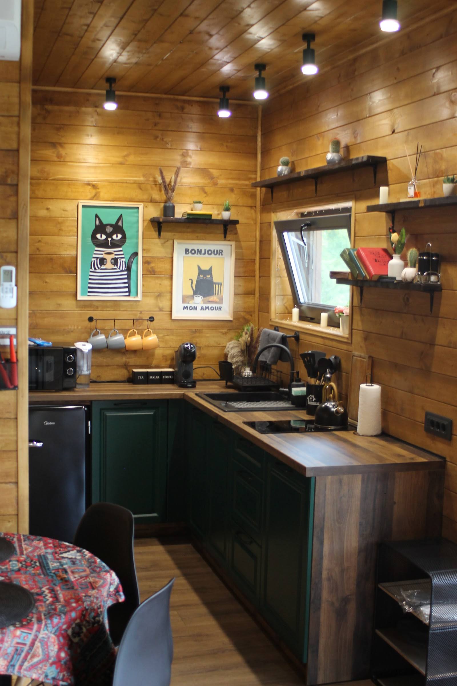 Cozy wood-paneled café interior with counter seating, pendant lighting, and artwork