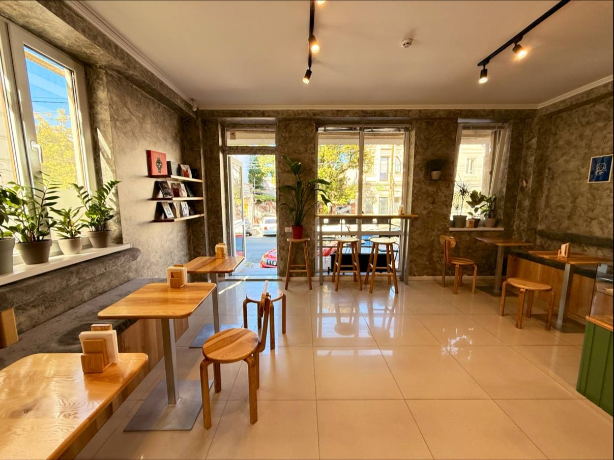 Bright, spacious interior cafe or restaurant with wooden furniture and polished floors