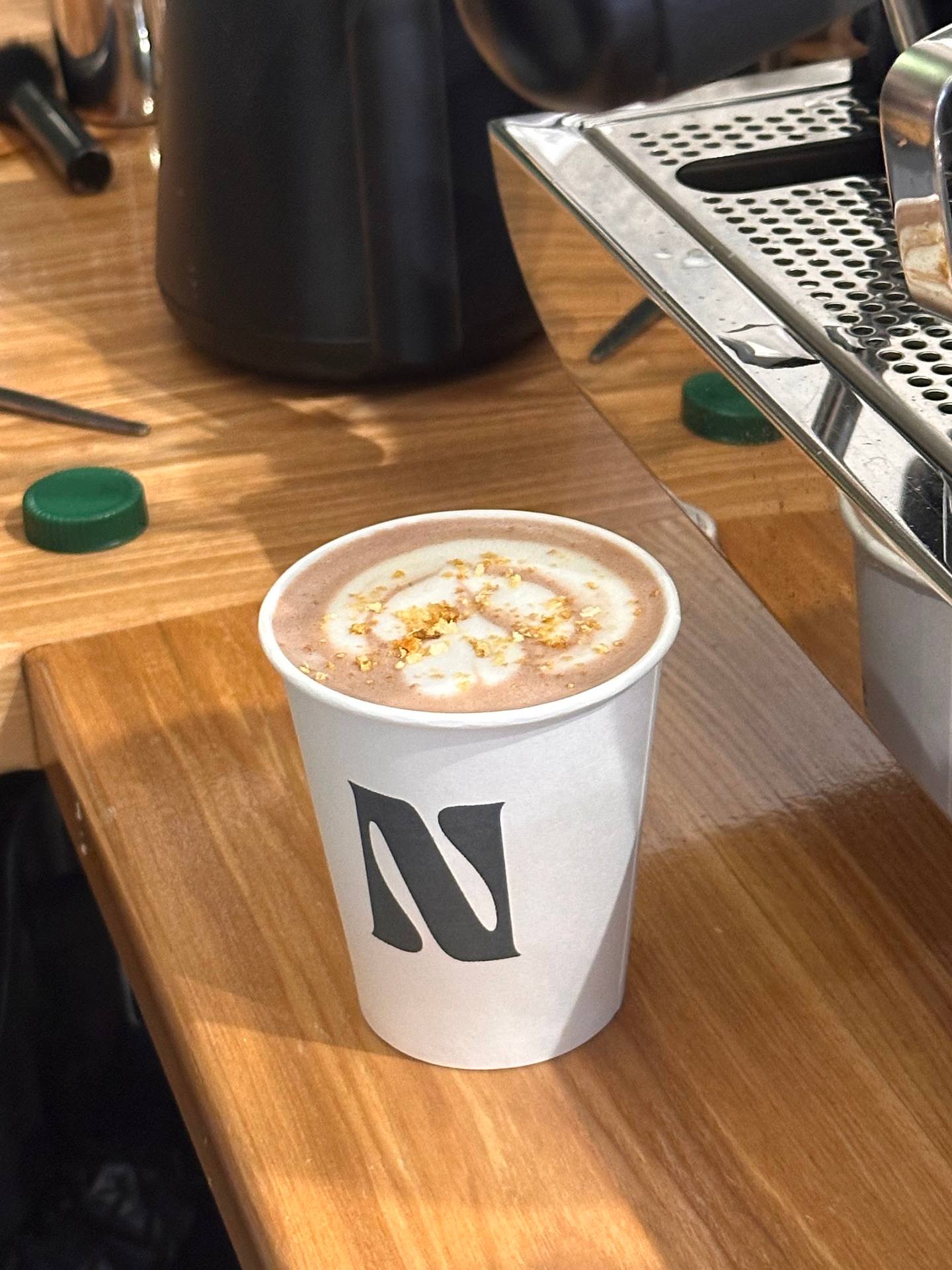 Specialty coffee drink with latte art in branded cup
