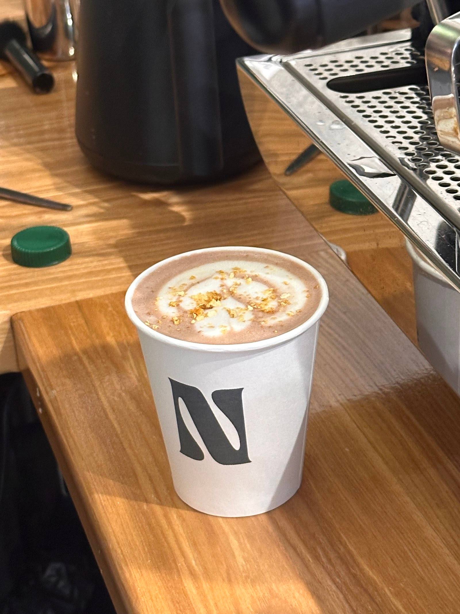 Specialty coffee drink with latte art in branded cup