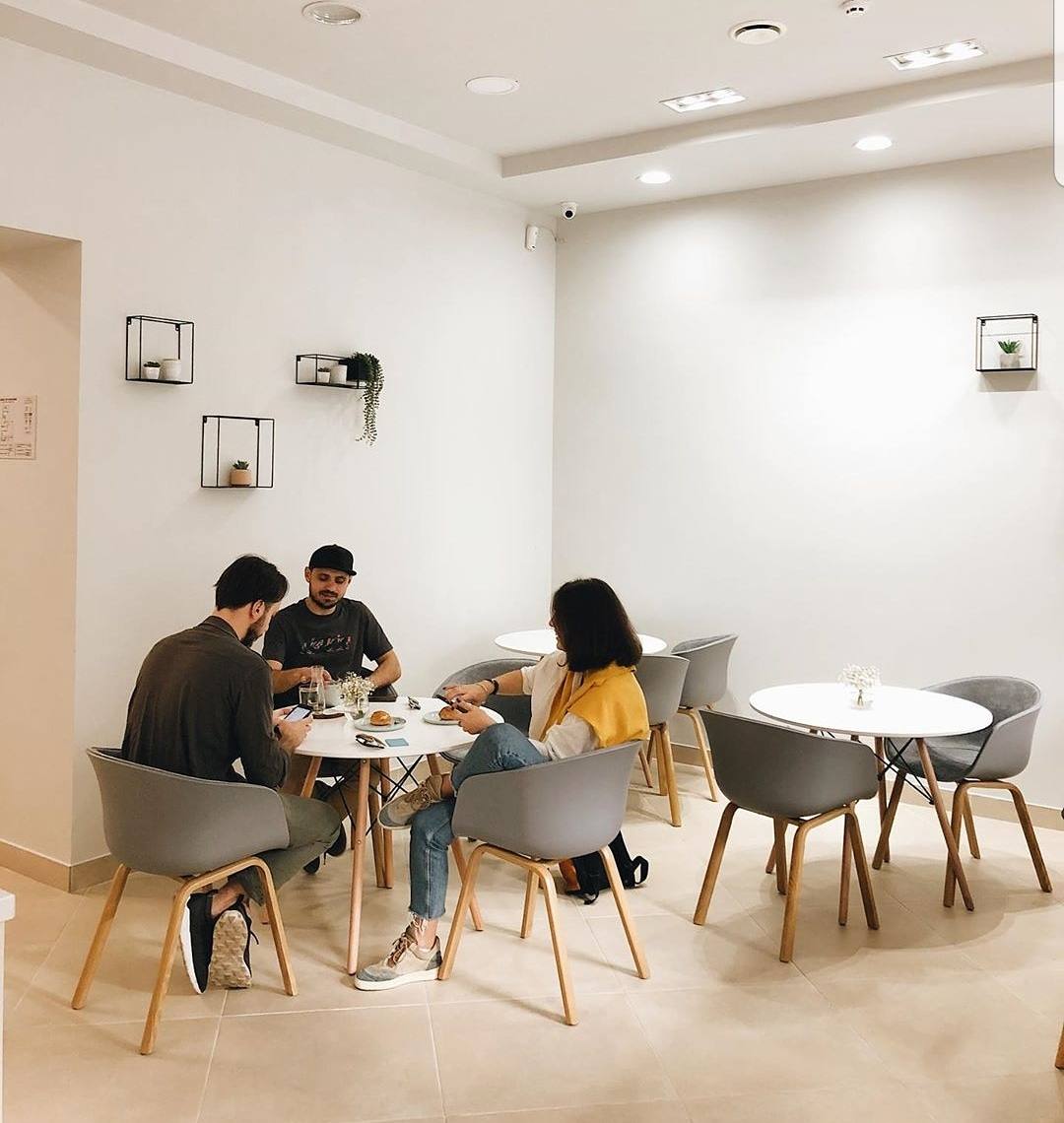 Bright minimalist cafe interior with natural wood furniture and ambient lighting