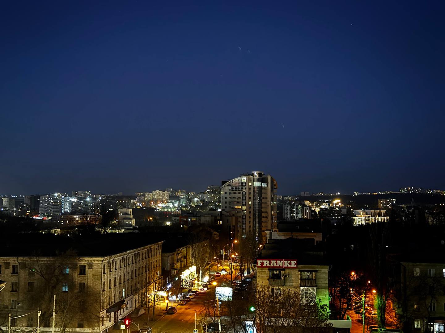 Nighttime cityscape view of a Moldovan urban area with illuminated buildings and streets