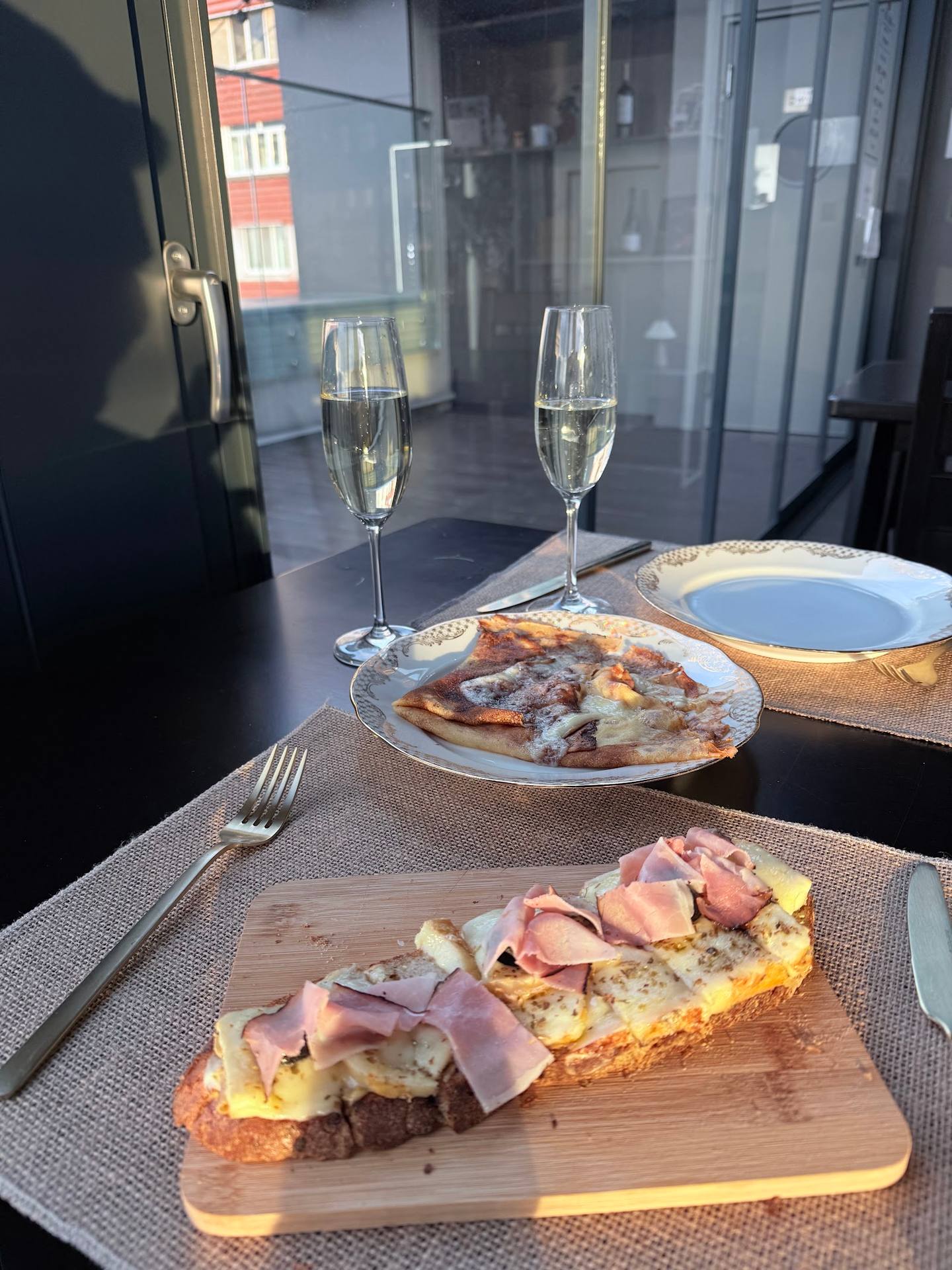 Plated brunch with charcuterie toast and champagne service at restaurant table