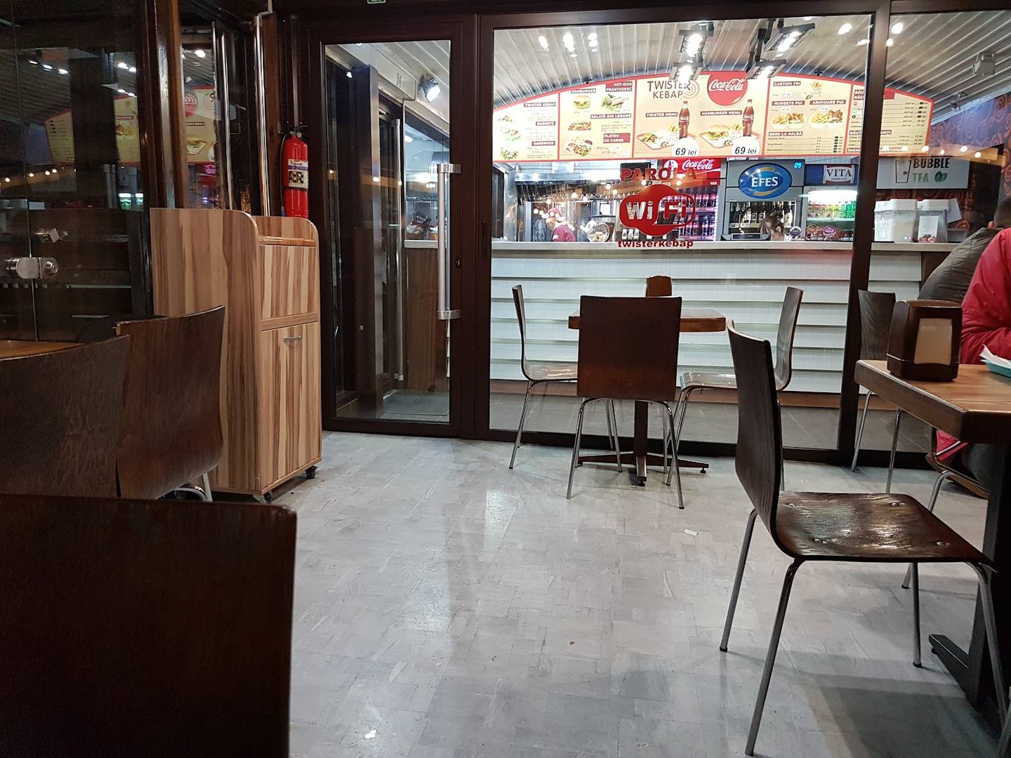 Bright modern cafe interior with counter seating and street-facing storefront
