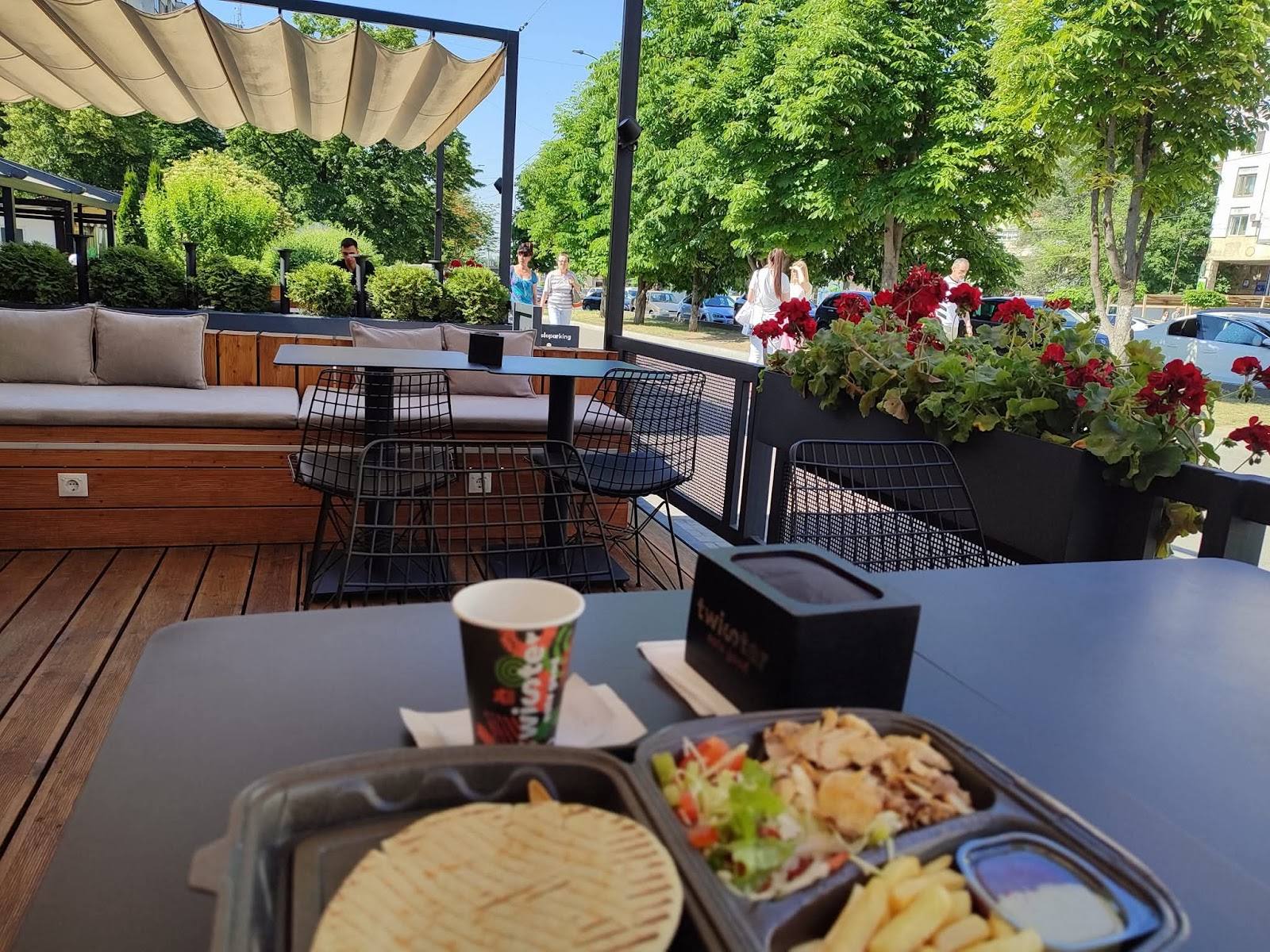 Outdoor terrace with food spread and beverage service at casual dining venue