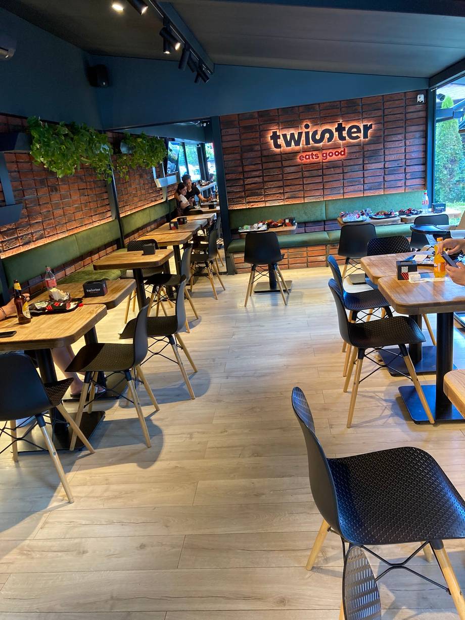 Twister Sports Bar interior with modern seating, gaming tables, and neon signage