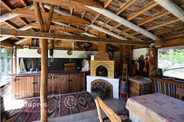 Rustic wooden interior with exposed beams, traditional furnishings and brick fireplace