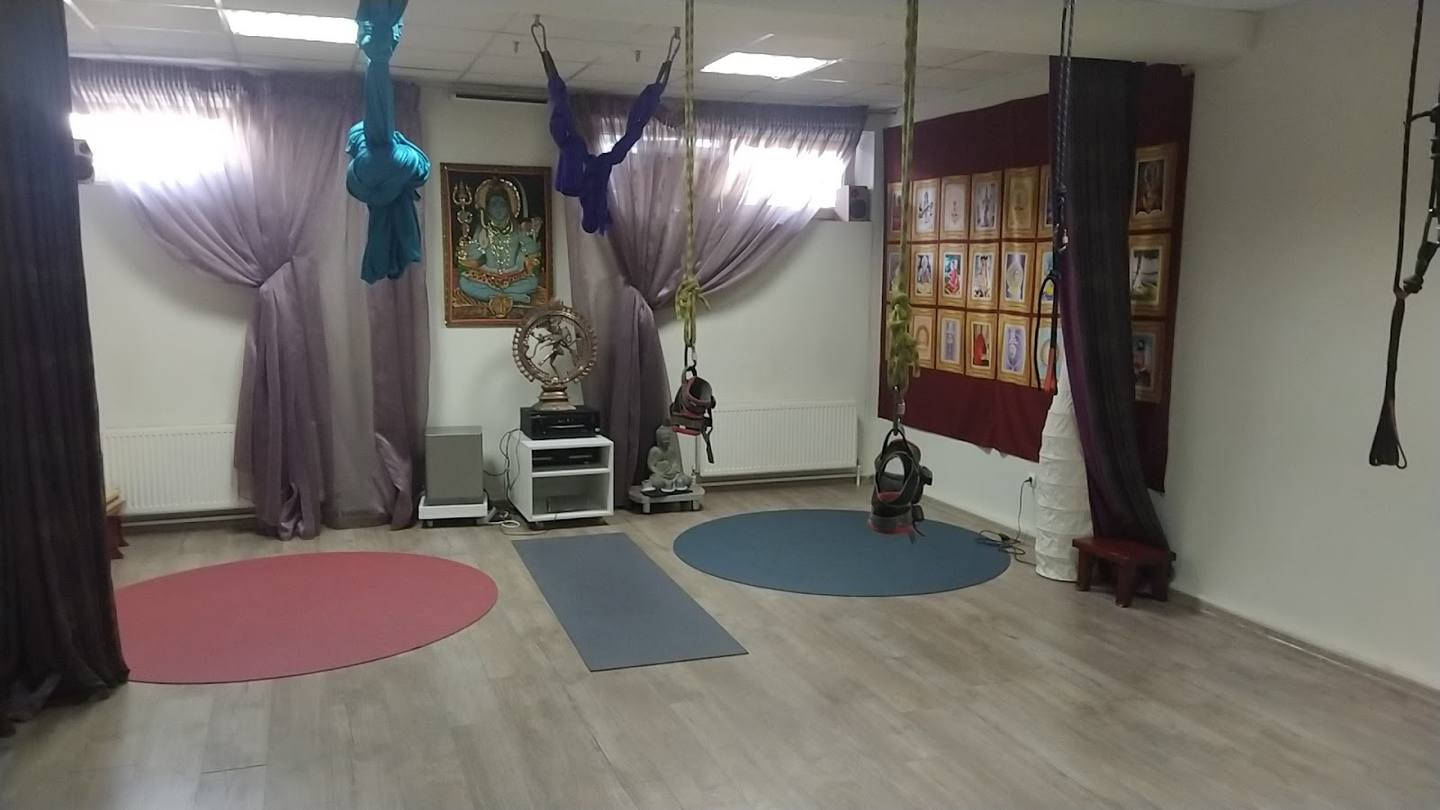 Bright activity studio with yoga mats, draped curtains, and flexible floor space for classes and events