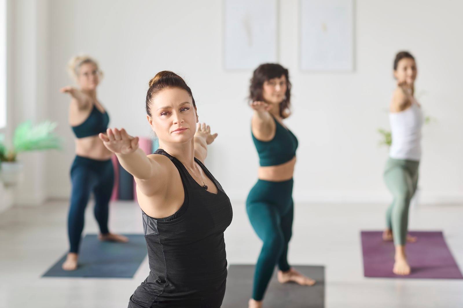 Group fitness class in progress with instructor leading exercise poses