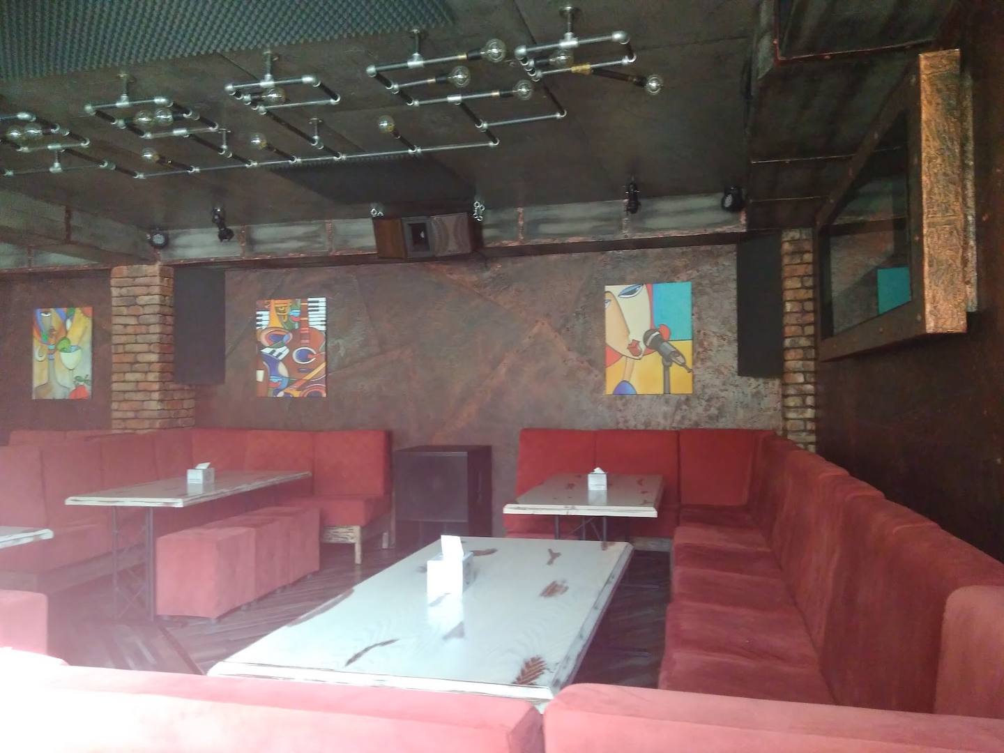 Red vinyl seating booths and gaming tables in casual entertainment venue