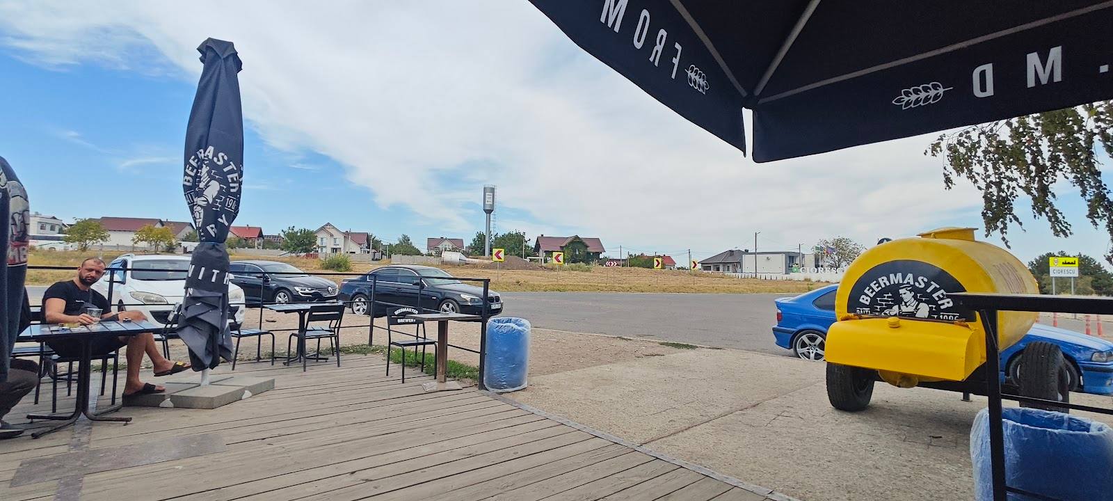 Karting venue with track-side terrace seating and branded karts visible