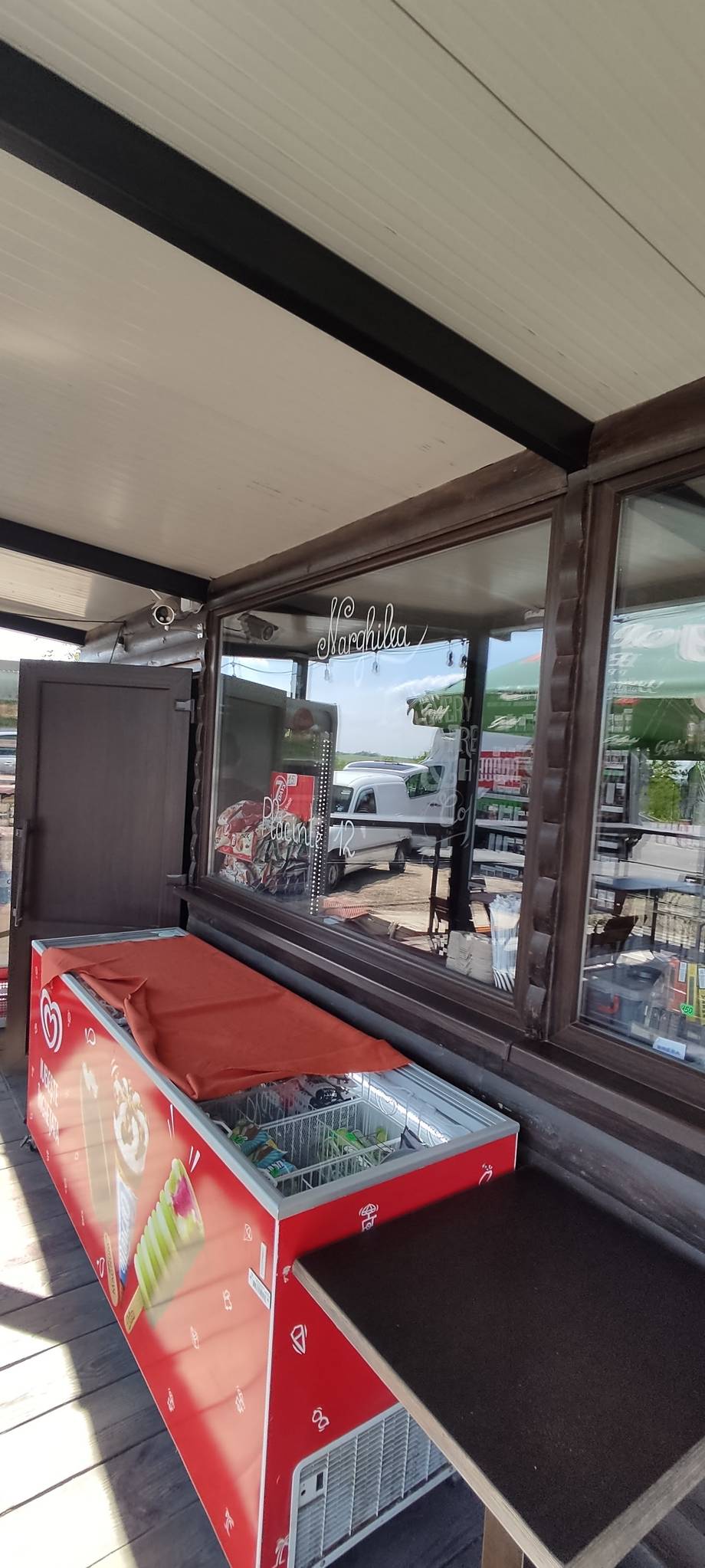 Counter service window with branded display cooler and menu signage