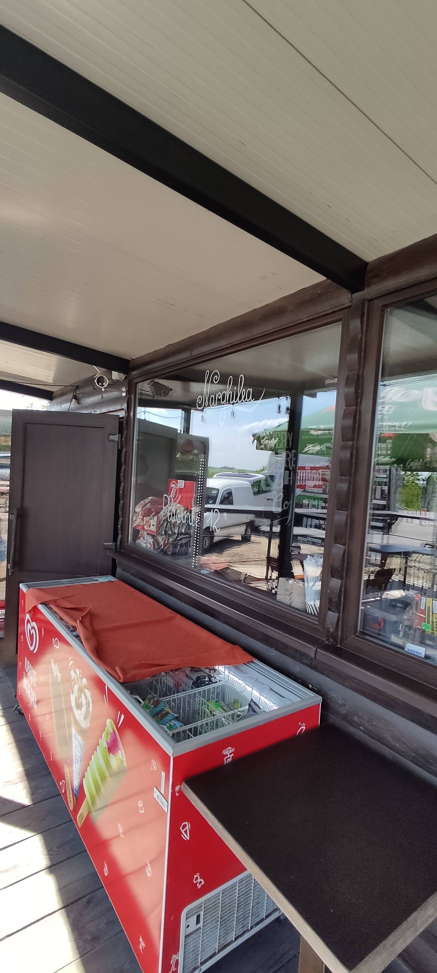 Counter service window with branded display cooler and menu signage