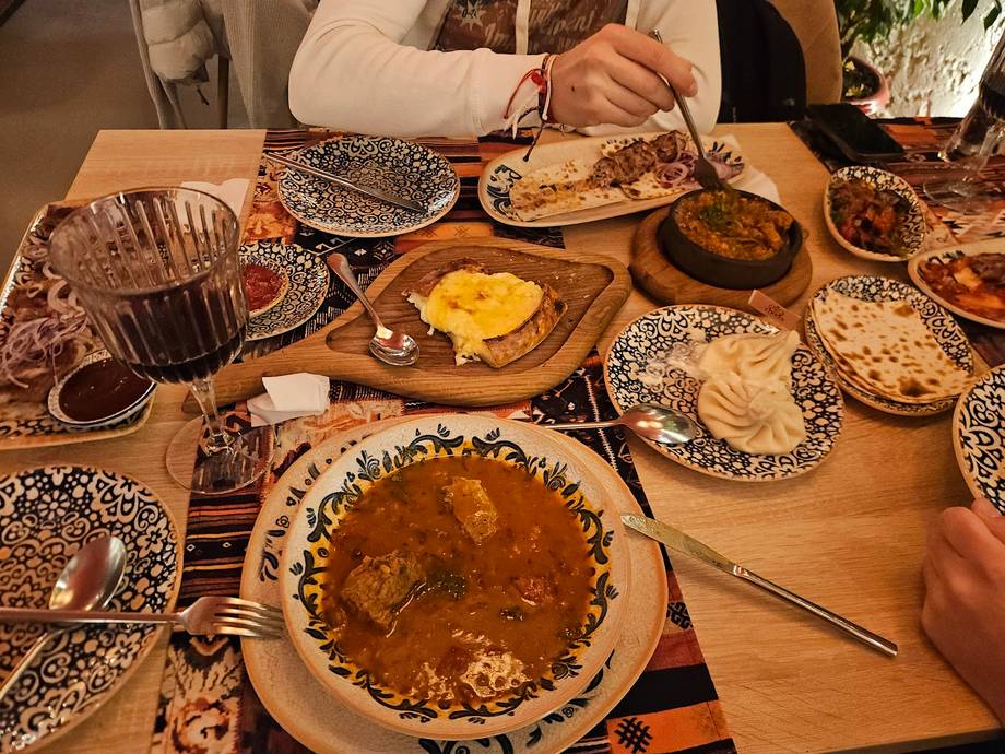 Traditional Moldovan feast with hand-pinched pastries and baked goods on rustic wooden table